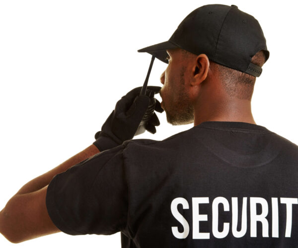 Black,Security,Man,With,Radio,Set,From,Behind